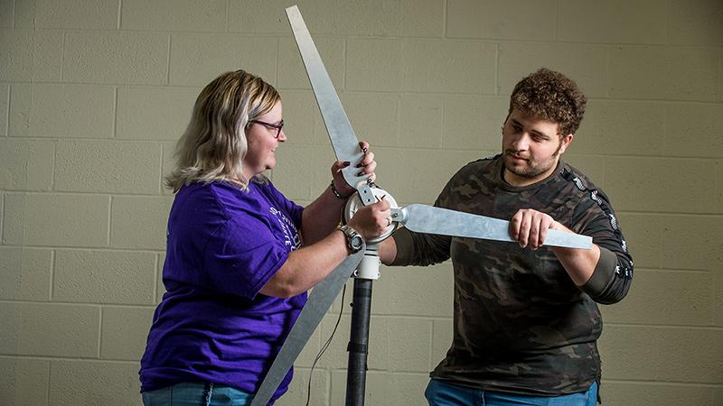 Mechanical Engineering students with wind turbine